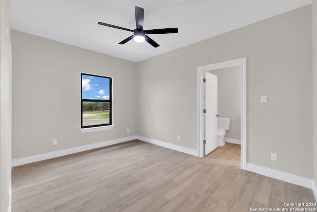 unfurnished bedroom with ensuite bathroom, ceiling fan, and light hardwood / wood-style flooring