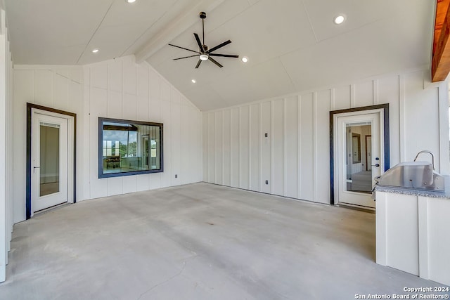 unfurnished living room featuring beam ceiling, ceiling fan, and high vaulted ceiling