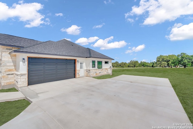 view of front of property with a garage and a front lawn