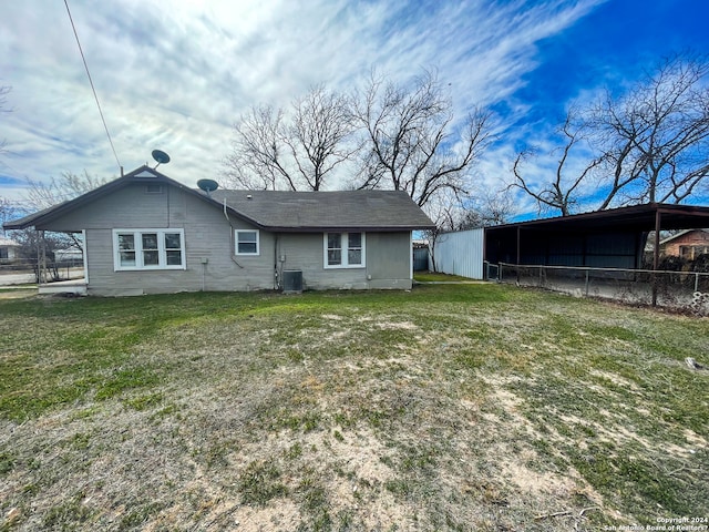 back of house with a lawn and central AC unit