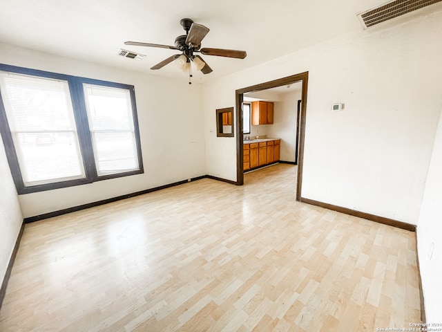 unfurnished room featuring ceiling fan and light hardwood / wood-style flooring