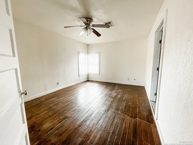 spare room with ceiling fan and dark hardwood / wood-style floors