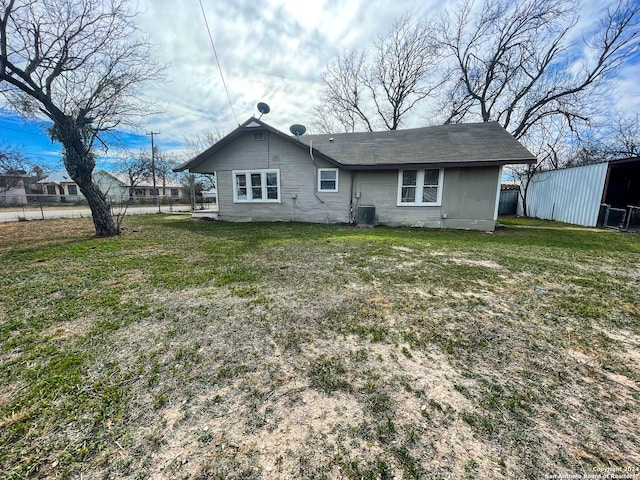 rear view of house featuring a yard