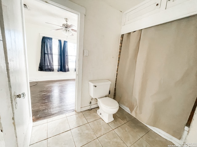 bathroom with ceiling fan, tile flooring, and toilet