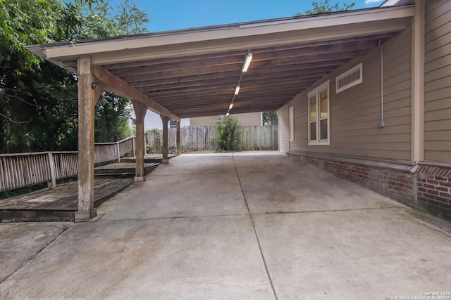 126 Lucas St, San Antonio, TX 78209 - view of patio featuring an attached carport, driveway, and fence
