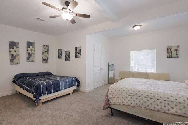 126 Lucas St, San Antonio, TX 78209 - carpeted bedroom with a closet, a ceiling fan, beamed ceiling, baseboards, and visible vents
