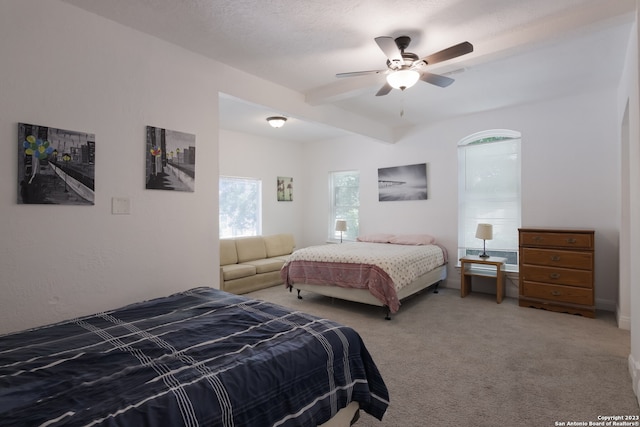 126 Lucas St, San Antonio, TX 78209 - bedroom featuring light carpet, ceiling fan, beam ceiling, and a textured ceiling