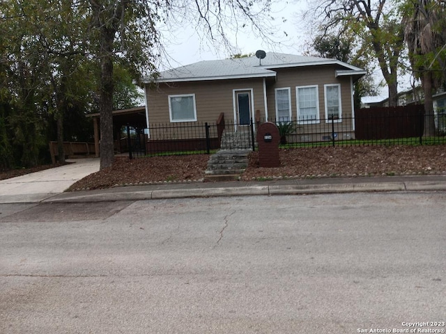 126 Lucas St, San Antonio, TX 78209 - bungalow-style house featuring an attached carport, a fenced front yard, and concrete driveway