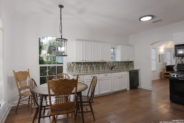 126 Lucas St, San Antonio, TX 78209 - dining space featuring arched walkways, baseboards, visible vents, and dark wood-type flooring