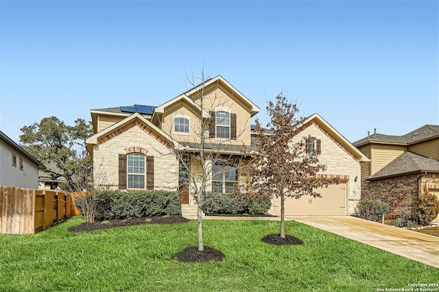 view of front facade featuring a front yard, solar panels, and a garage