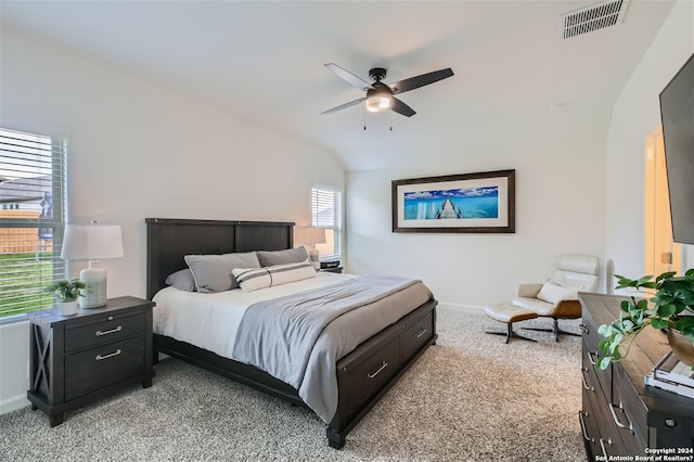 bedroom featuring light carpet, lofted ceiling, and ceiling fan