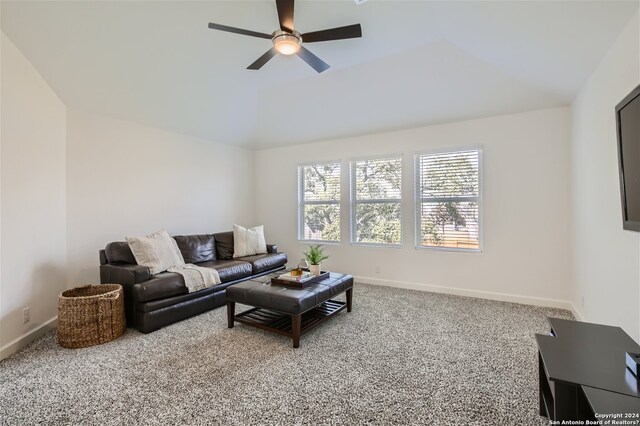 carpeted living room with lofted ceiling and ceiling fan