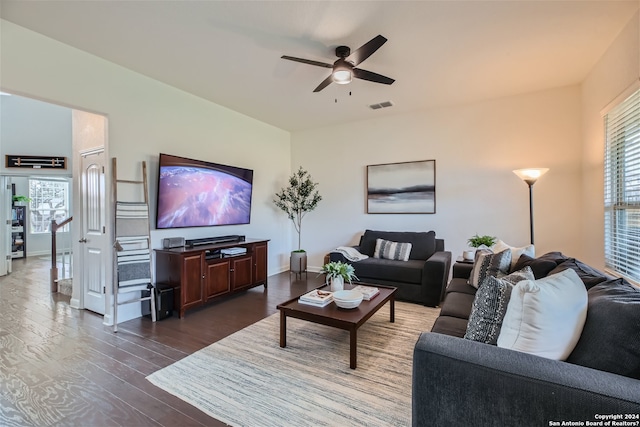 living room featuring dark hardwood / wood-style floors and ceiling fan