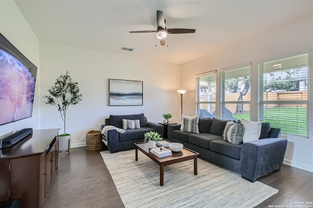 living room with dark hardwood / wood-style floors and ceiling fan