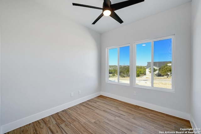 empty room with ceiling fan and light wood-type flooring