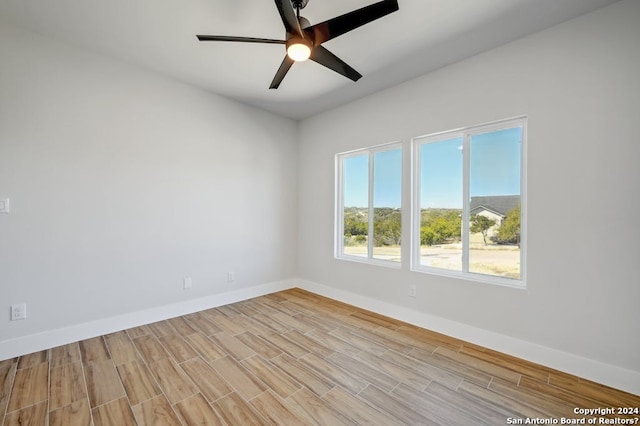 unfurnished room with ceiling fan and light wood-type flooring