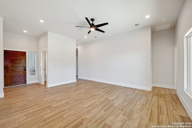 spare room with ceiling fan and light wood-type flooring