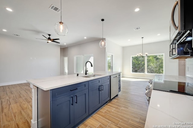 kitchen with decorative light fixtures, ceiling fan with notable chandelier, dishwashing machine, and sink