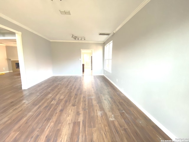 spare room with dark hardwood / wood-style flooring and ornamental molding