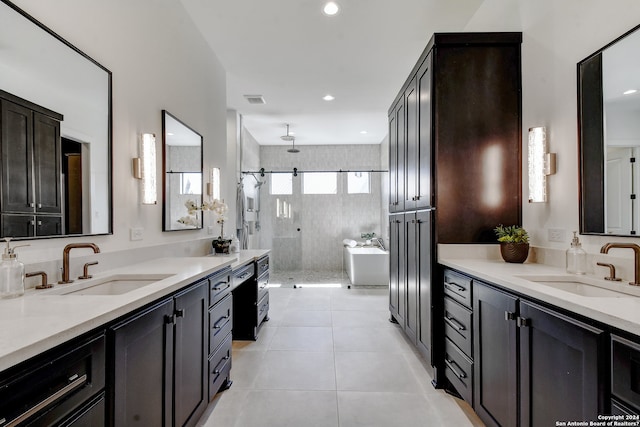 bathroom with tiled shower, tile floors, and vanity