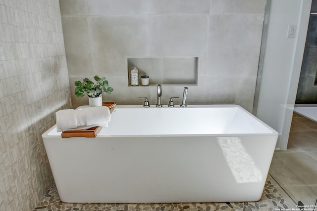 bathroom with tile walls and tile flooring