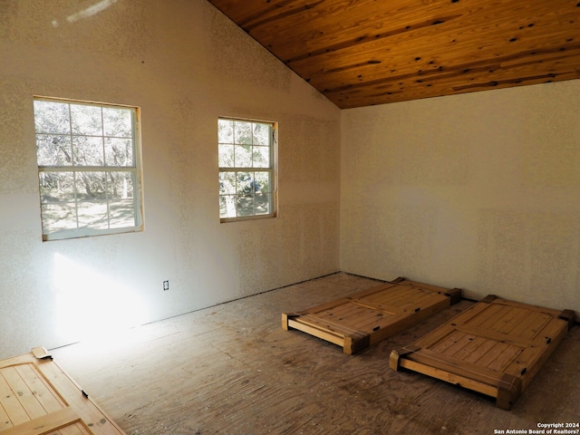 spare room with a wealth of natural light, vaulted ceiling, and wooden ceiling