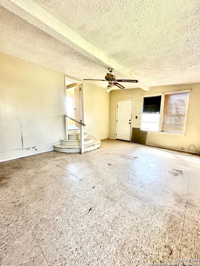 spare room featuring a textured ceiling and ceiling fan