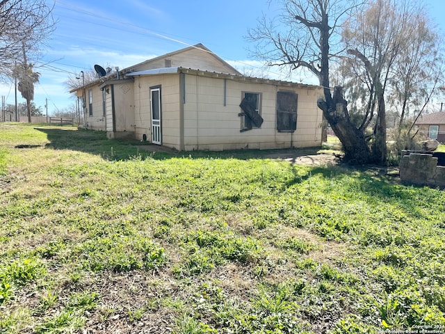 view of side of property featuring a yard