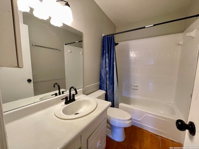 full bathroom featuring shower / tub combo, oversized vanity, toilet, and hardwood / wood-style flooring