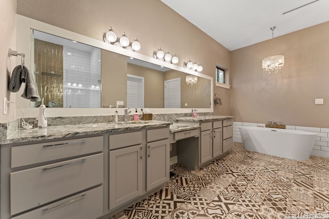 bathroom with a notable chandelier, tile floors, and dual bowl vanity