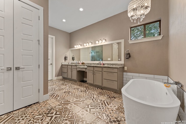 bathroom with tile flooring, a bathing tub, dual vanity, and an inviting chandelier