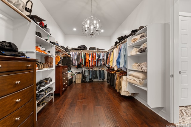 walk in closet featuring dark hardwood / wood-style floors and a chandelier