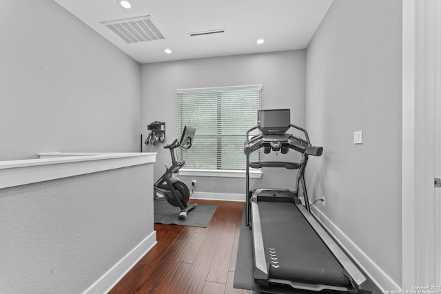 workout room with dark hardwood / wood-style flooring