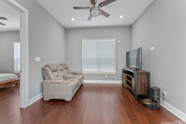 sitting room with dark hardwood / wood-style floors and ceiling fan