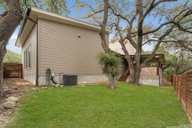 exterior space with a yard and central AC