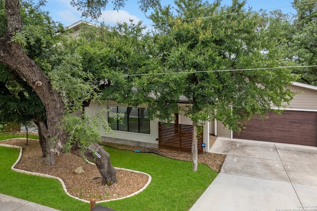 view of front of house with a front yard and a garage