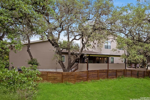 rear view of house with a yard