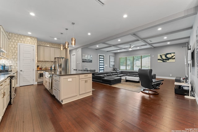 kitchen featuring coffered ceiling, dark hardwood / wood-style floors, an island with sink, and tasteful backsplash