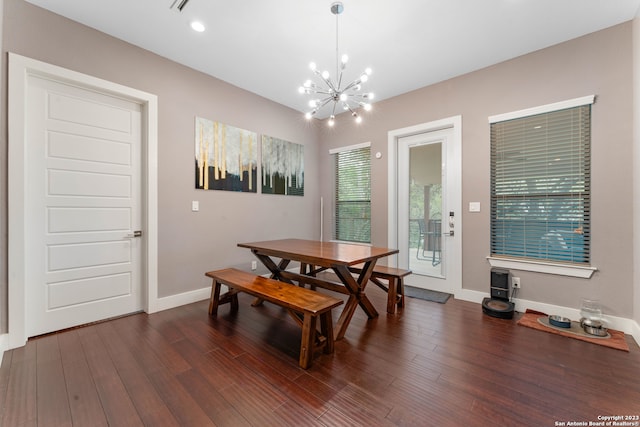 dining room featuring an inviting chandelier and dark hardwood / wood-style floors