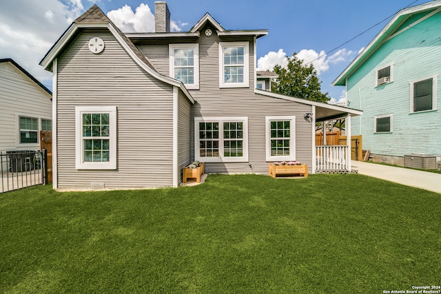 rear view of house with a yard