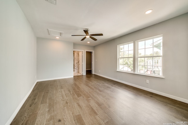 empty room with ceiling fan and dark wood-type flooring