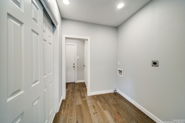 clothes washing area with hookup for an electric dryer, dark hardwood / wood-style flooring, and hookup for a washing machine