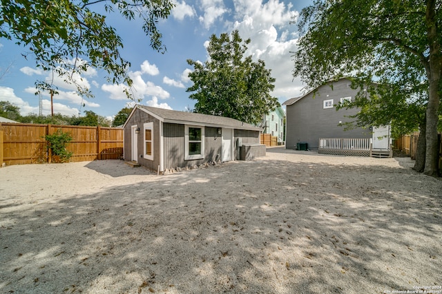 back of property with an outdoor structure