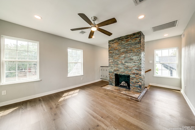 unfurnished living room with light hardwood / wood-style floors, ceiling fan, and a fireplace