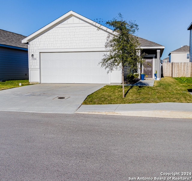 view of front of house with a front yard and a garage