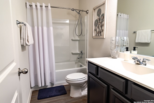 full bathroom with vanity, toilet, hardwood / wood-style flooring, and shower / tub combo with curtain