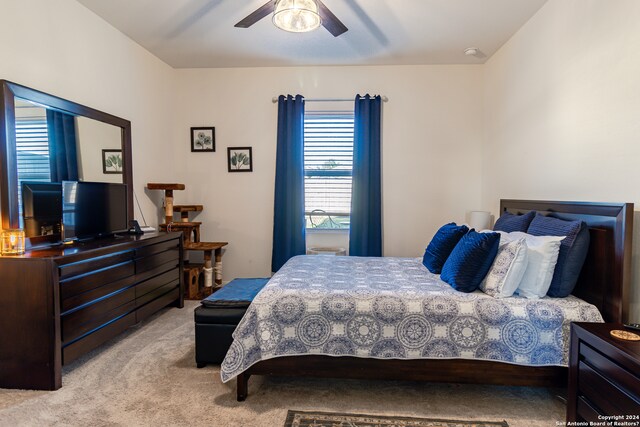 bedroom featuring light carpet and ceiling fan