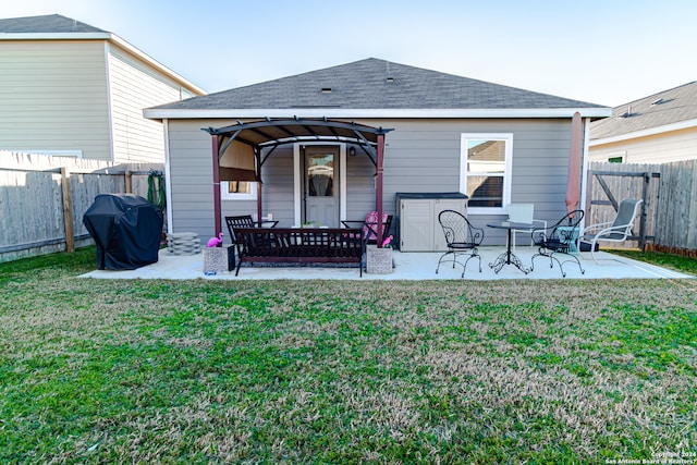 rear view of property with a patio and a yard