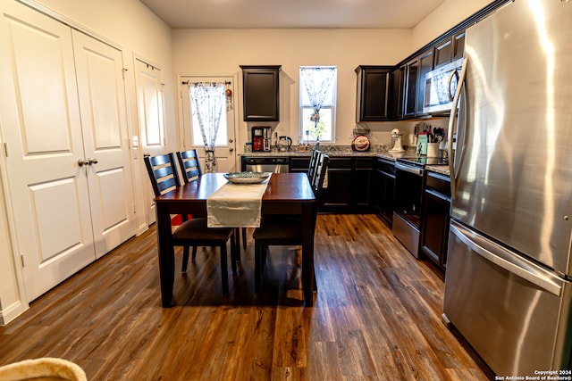 kitchen with stainless steel appliances and dark wood-type flooring