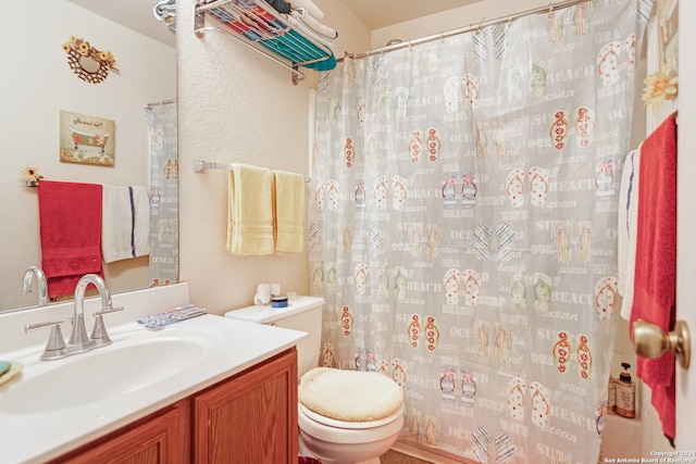 bathroom featuring toilet and vanity